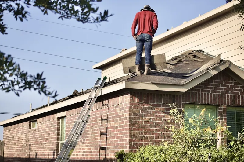 Professional roofer working on a residential roof in Buckhout Corners
